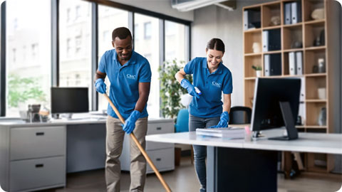 happy janitors cleaning an office